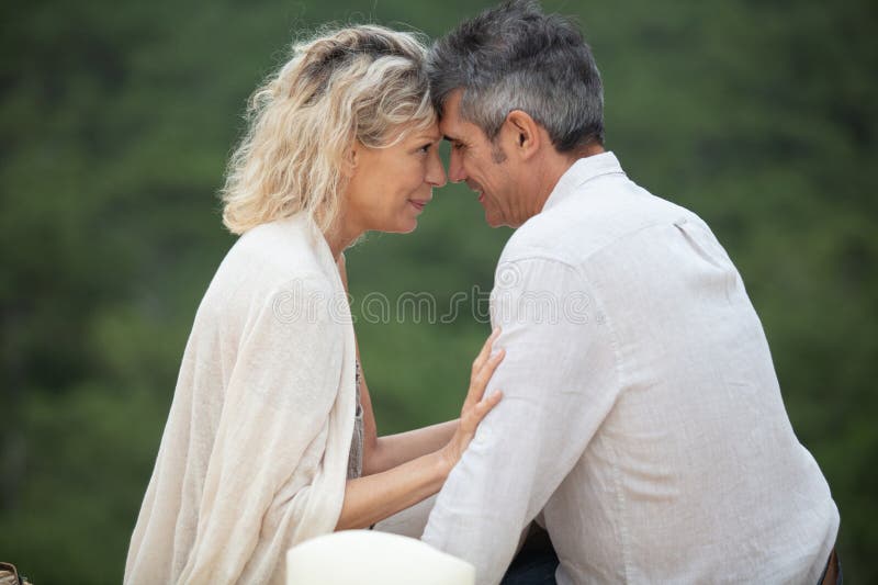 Happy hugging couple on beach stock image