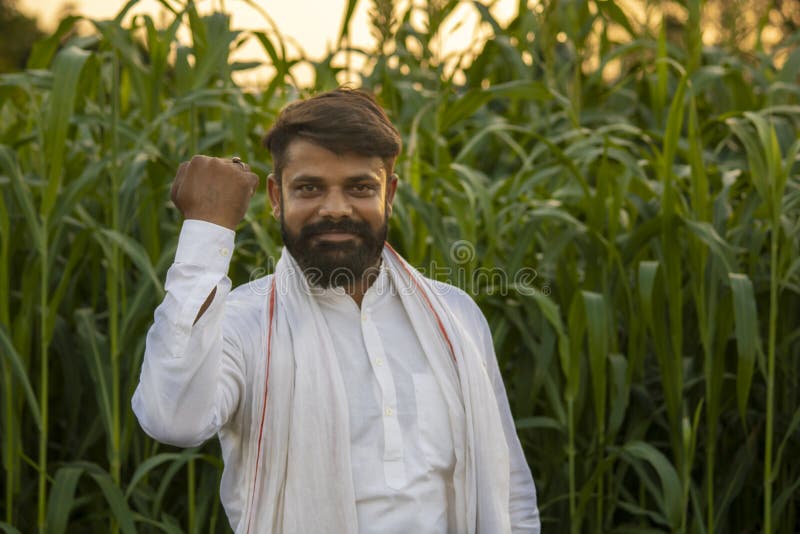 Happy Indian farmer in fodder field