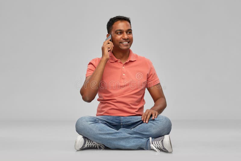 Happy indian man calling on smartphone