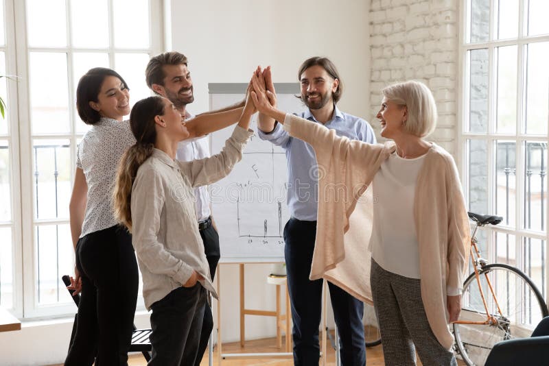Happy international team giving high five to each other. royalty free stock photos Happy international team giving high five to each other. royalty free stock photos