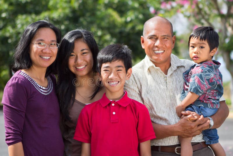 Portrait of a happy Filipino family, mother, father and three children, living in Hawaii. Portrait of a happy Filipino family, mother, father and three children, living in Hawaii.