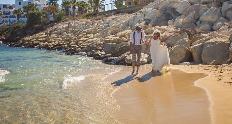 Happy just married young wedding couple celebrating and have fun at beautiful beach royalty free stock photo Happy just married young wedding couple celebrating and have fun at beautiful beach royalty free stock photo