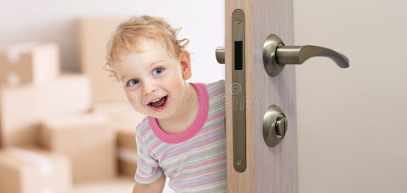 Happy kid behind door in new room