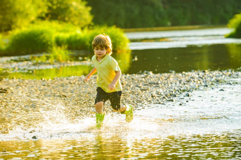 Happy kid on nature. Cute child having fun on River.