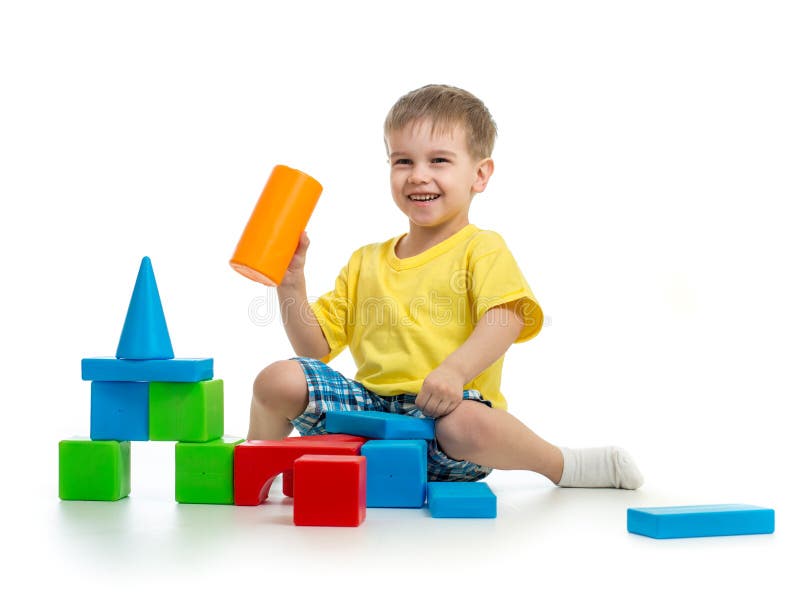 Happy kid playing with colorful building blocks on white royalty free stock image