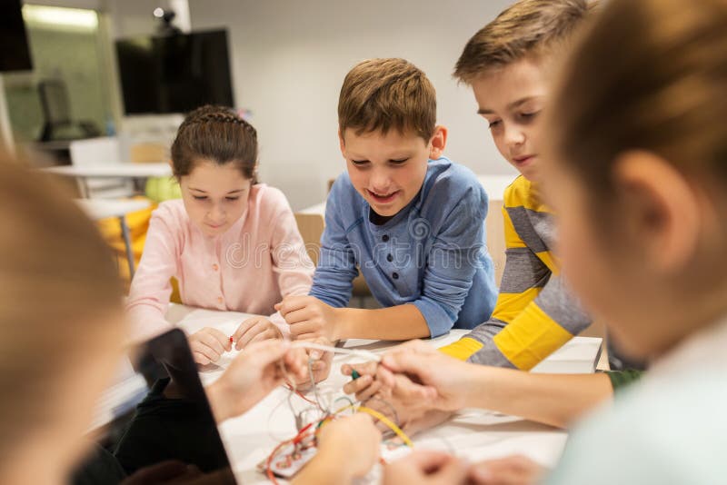 Happy kids with invention kit at robotics school