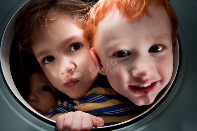 Happy kids looking through window porthole