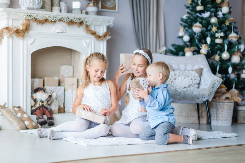 Happy kids near Xmas tree