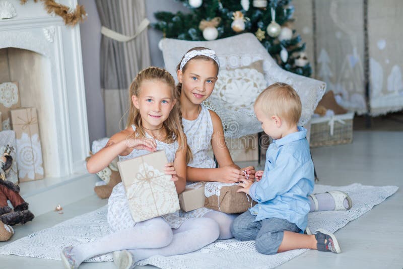 Happy kids near Xmas tree