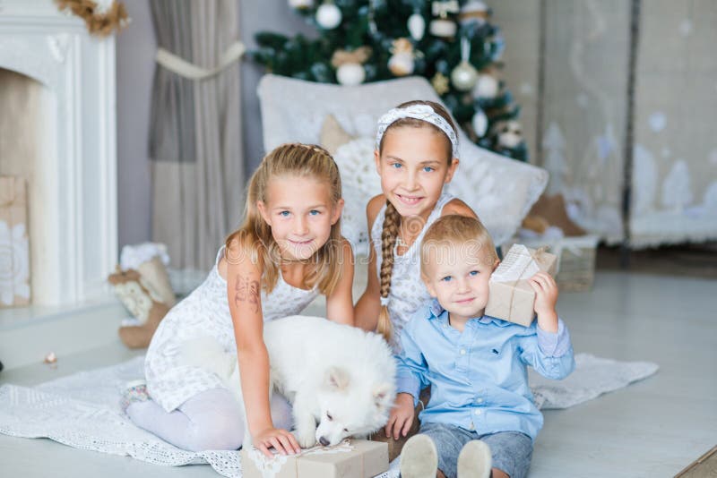 Happy kids near Xmas tree