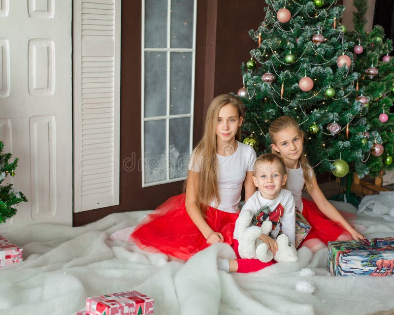 Happy kids near Xmas tree