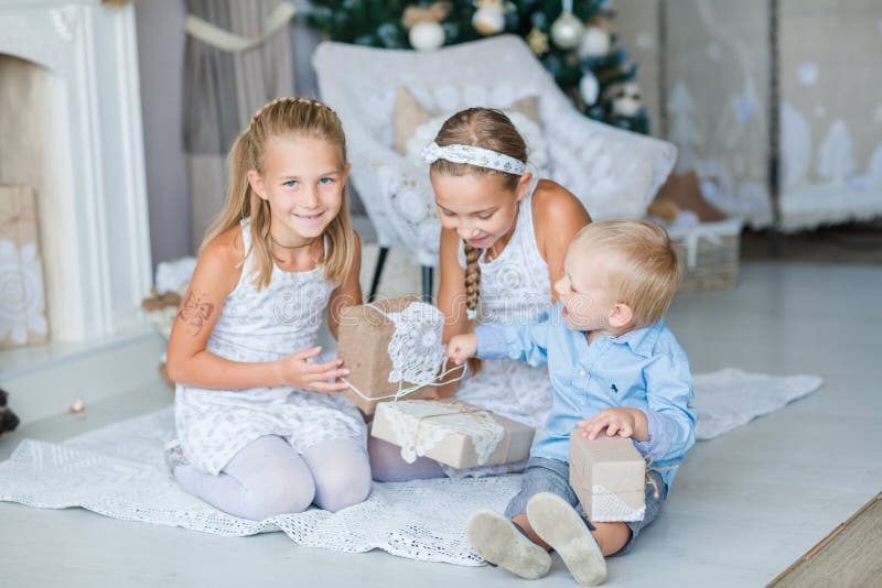 Happy kids near Xmas tree