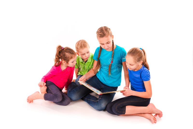 Happy kids reading a book on white