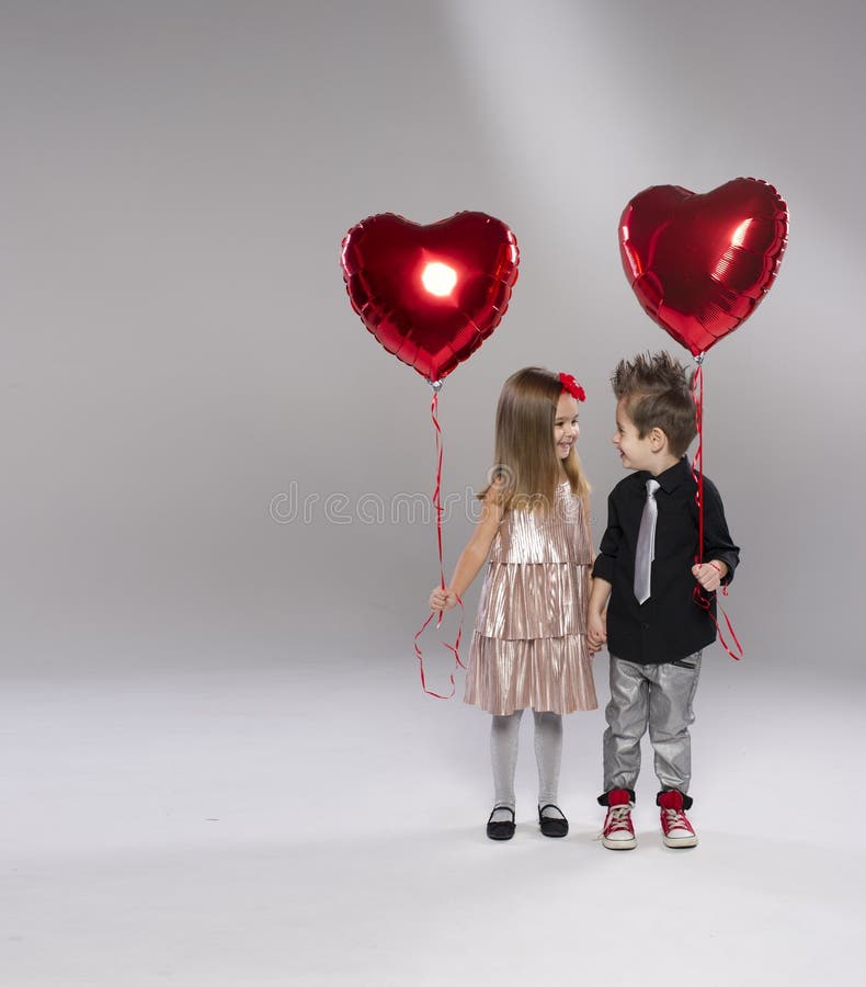 Happy kids with red heart balloon royalty free stock image