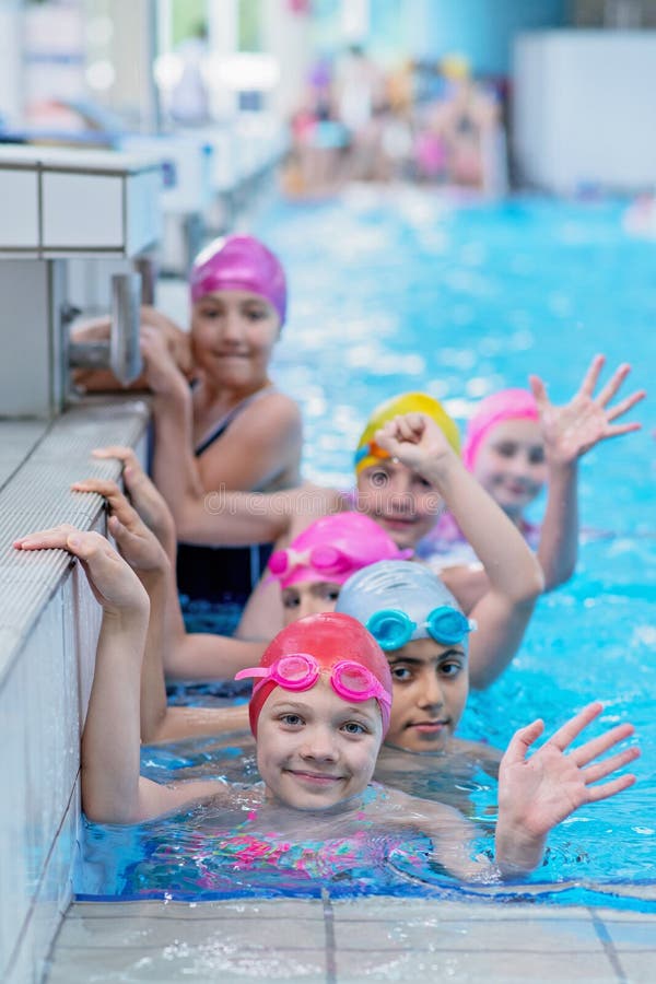 Happy Kids at the Swimming Pool. Young and Successful Swimmers Pose