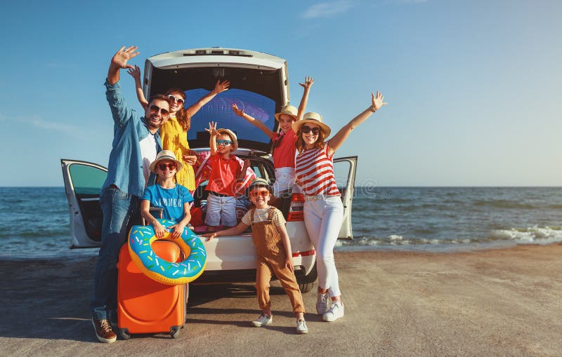 Happy large family mother father and children in summer auto journey travel by car on beach. Happy large family mother father and children in summer auto journey travel by car on beach