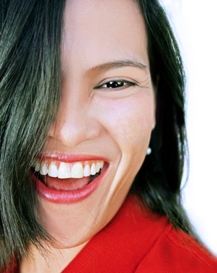 Happy and laughing asian or latina beauty with black hair partly covering face. Fit for bright future, dentist, dental care, cosmetic, etc. concept or lay-out. Happy and laughing asian or latina beauty with black hair partly covering face. Fit for bright future, dentist, dental care, cosmetic, etc. concept or lay-out.