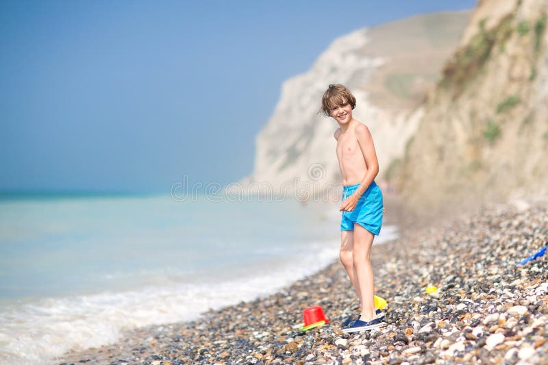 Happy laughing child playing on a beautiful beach stock photos Happy laughing child playing on a beautiful beach stock photos