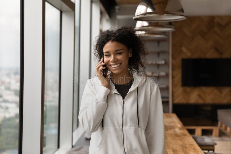 Young black woman make phone call in good mood