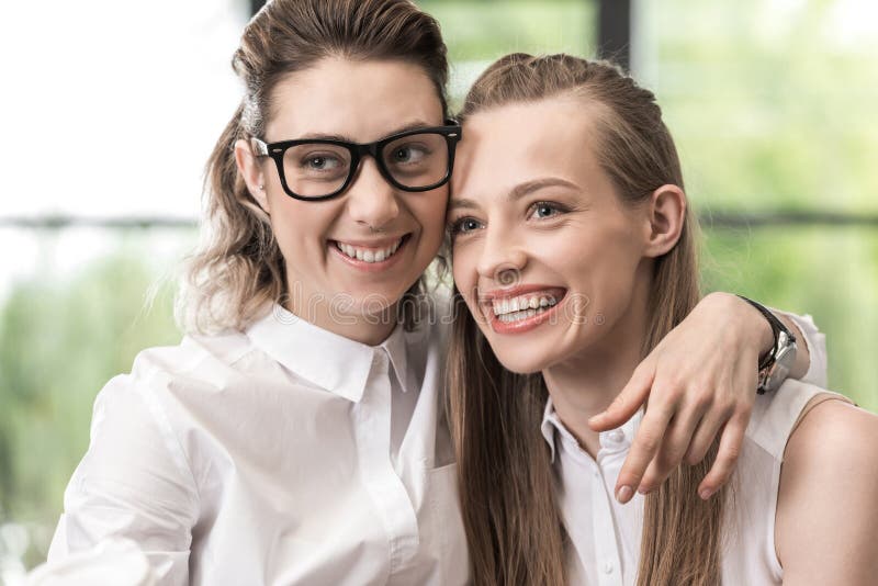 Happy Lesbian Couple Hugging Each Other And Looking Aside Stock Image 