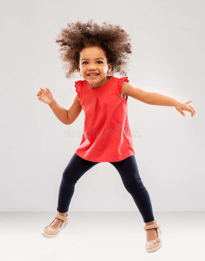 Happy Little African American Girl Jumping Stock Photo - Image of ...