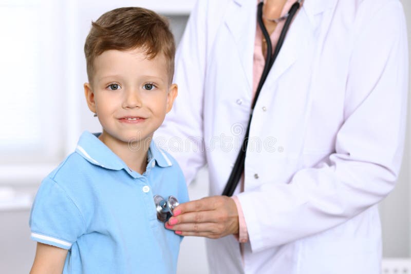 Happy little boy having fun while is being examine by doctor by stethoscope. Health care, insurance and help concept