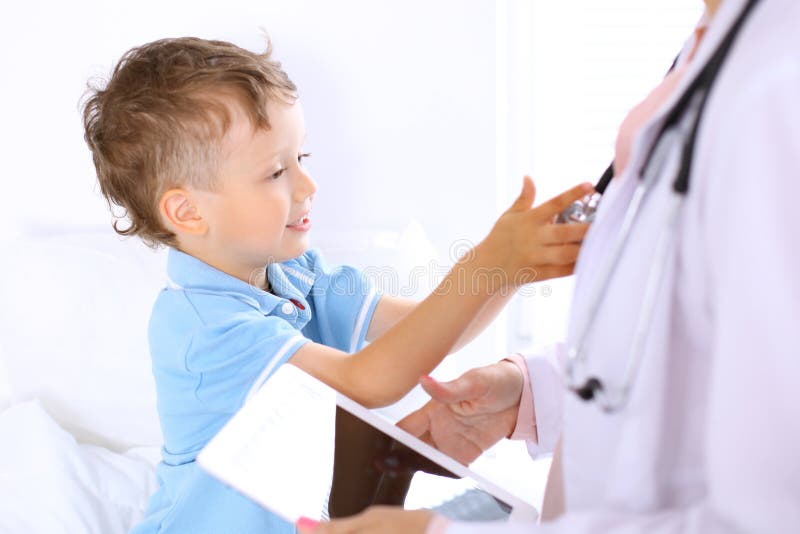 Happy little boy with his doctor after health exam