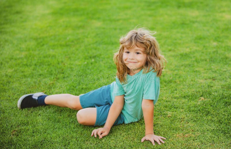 Happy Little Boy Laying on the Grass in Park. Stock Photo - Image of ...