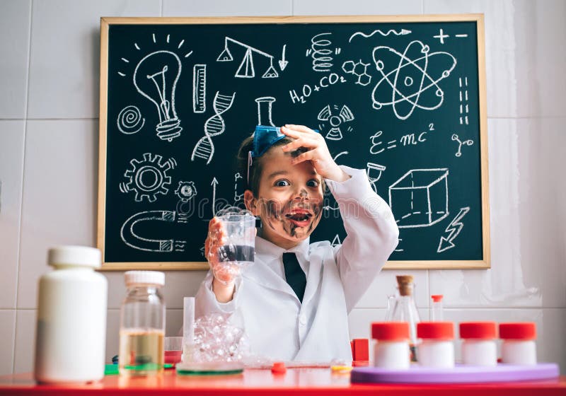 Portrait of surprised little scientist with dirty face holding glass with soap foam after a crazy experiment. Portrait of surprised little scientist with dirty face holding glass with soap foam after a crazy experiment