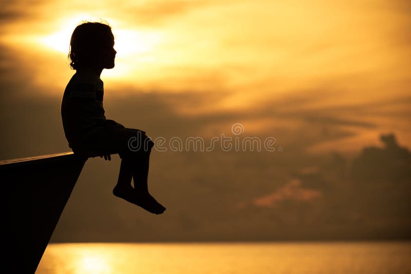 Happy little boy sitting on beach