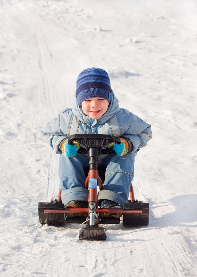 Happy little boy sledging at sleig