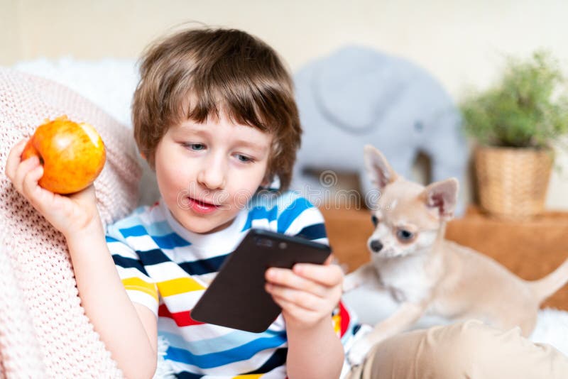 Happy Little Child Boy Playing Online Game, Watching Video on Cellphone and Eating Apple. Smiling Small Kid Using Funny Stock Photo - Image of digital, cheerful: 184009546 Happy Little Child Boy Playing Online Game, Watching Video on Cellphone and Eating Apple. Smiling Small Kid Using Funny Stock Photo - Image of digital, cheerful: 184009546