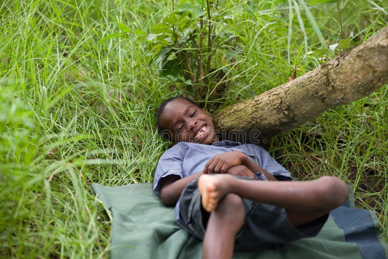 Happy little child lying on the grass stock photo Happy little child lying on the grass stock photo