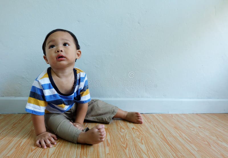 Happy little cute asian boy sat and looked innocent stock images Happy little cute asian boy sat and looked innocent stock images