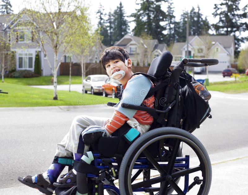 Happy little disabled boy in wheelchair