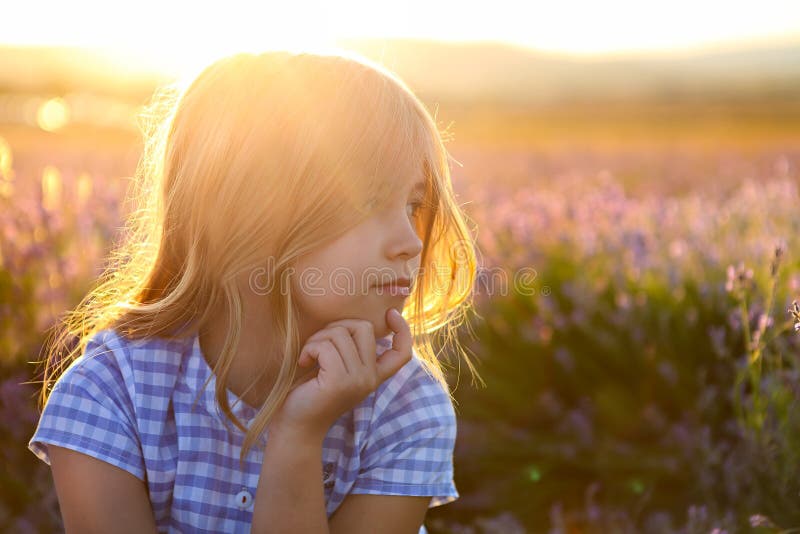 Happy little girl blonde with long hair at sunset in lavender field royalty free stock photos Happy little girl blonde with long hair at sunset in lavender field royalty free stock photos