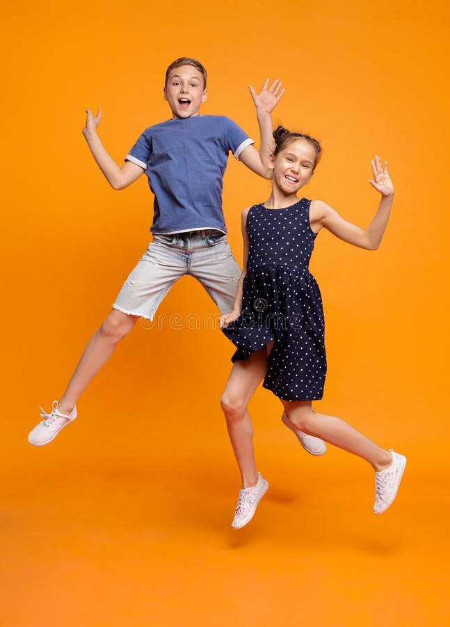 Happy little girl and boy jumping for joy together royalty free stock images Happy little girl and boy jumping for joy together royalty free stock images
