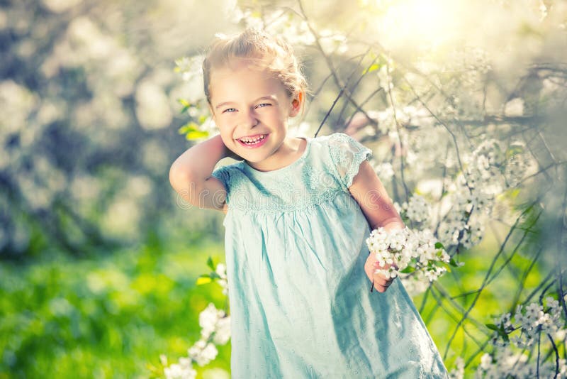 Happy Little Girl in Cherry Blossom Garden Stock Photo - Image of ...