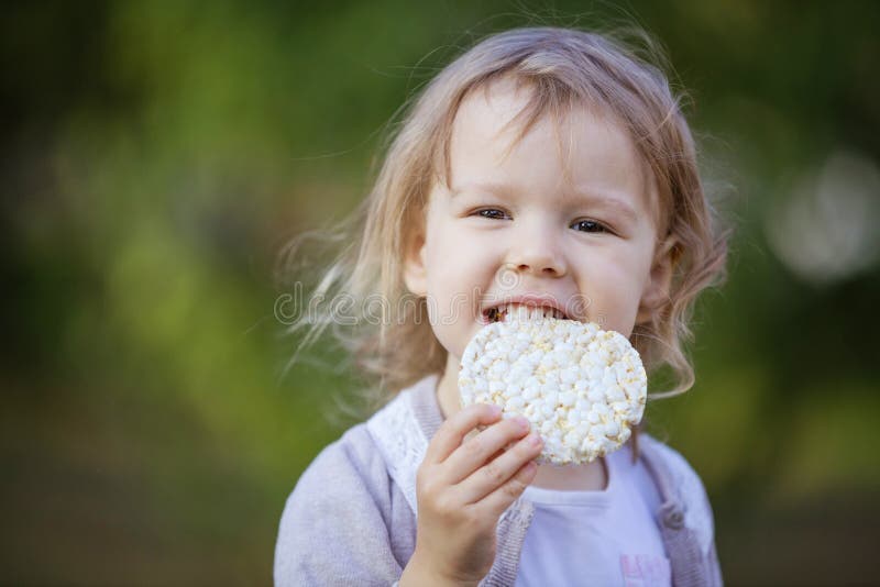 Happy Little Girl Eating Corn Cracker Outdoors Stock Image Image of