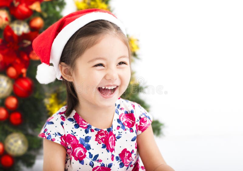 Happy little girl in front of christmas tree