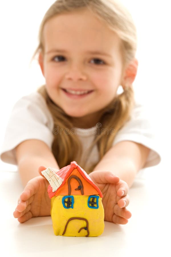 Happy little girl with hand made clay house