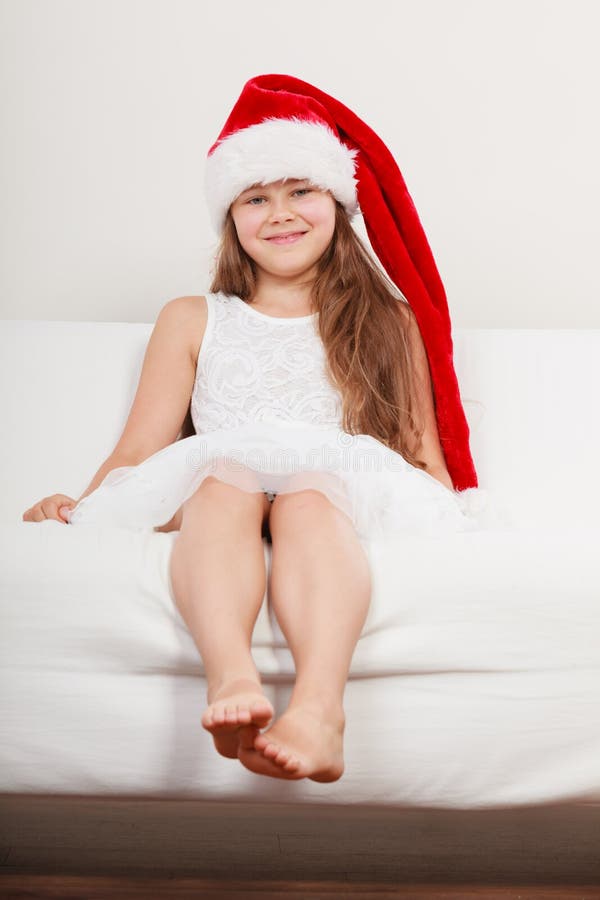 Happy little girl kid in santa hat. Christmas.