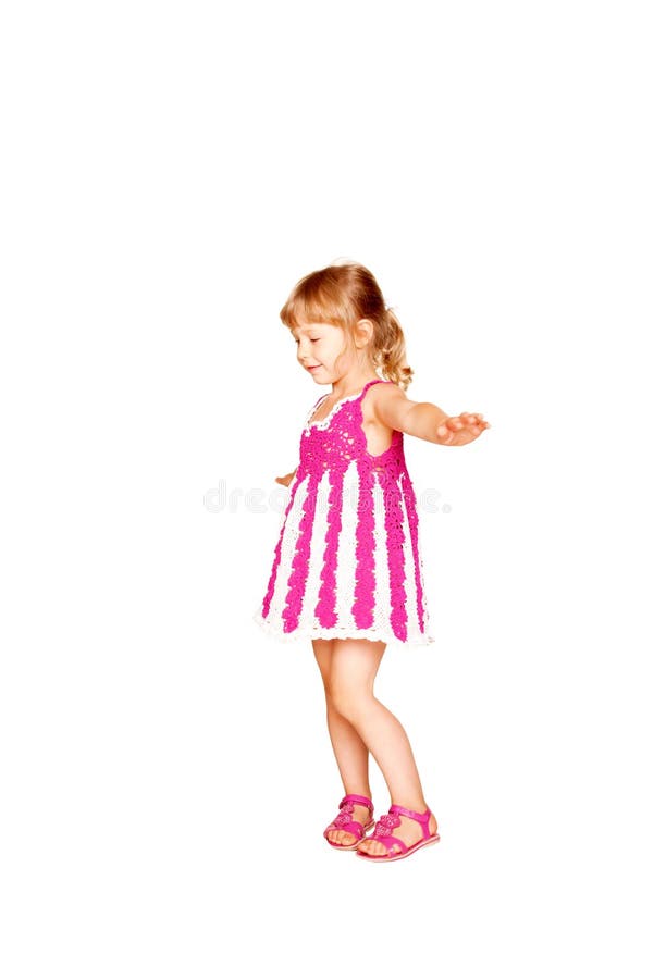 Happy little girl in knitted pink dress dancing. royalty free stock photo Happy little girl in knitted pink dress dancing. royalty free stock photo