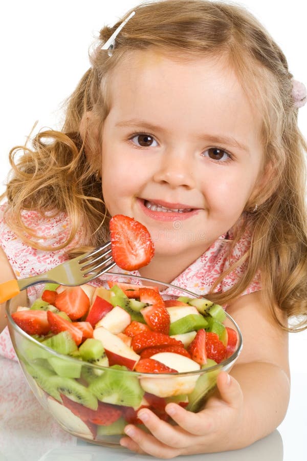 Happy little girl with a large bowl of fruit salad