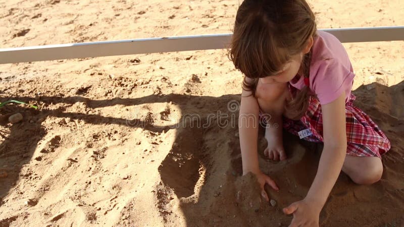 Happy Little Girl in Pink Plays with Sand on Playground at Summer Stock Footage - Video of dress, face: 56447920 