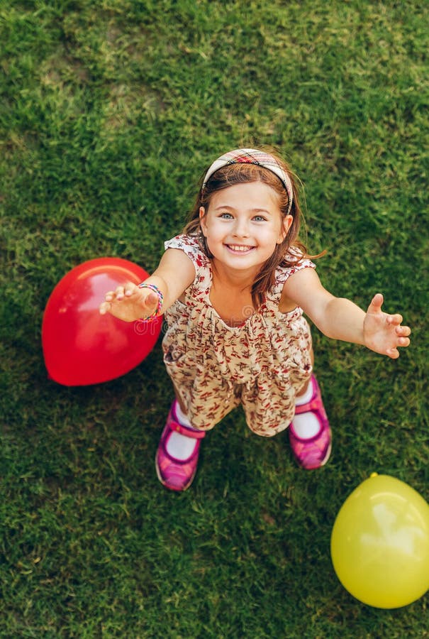 Happy little girl playing with colorful balloons royalty free stock photography Happy little girl playing with colorful balloons royalty free stock photography