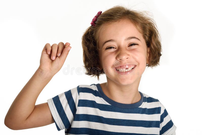 Happy little girl showing her first fallen tooth.