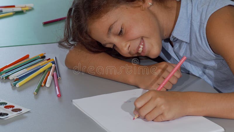 https://thumbs.dreamstime.com/b/happy-little-girl-smiling-drawing-her-sketchbook-sliding-shot-cute-young-schoolgirl-enjoying-cheerfully-working-133651661.jpg