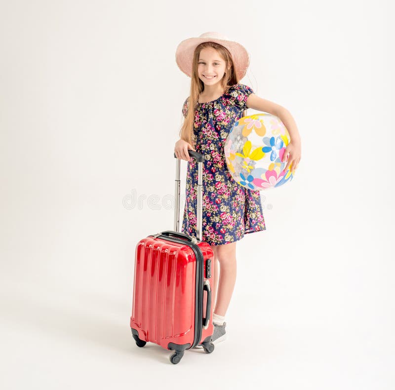 Happy little girl is standing near a suitcase royalty free stock photos Happy little girl is standing near a suitcase royalty free stock photos
