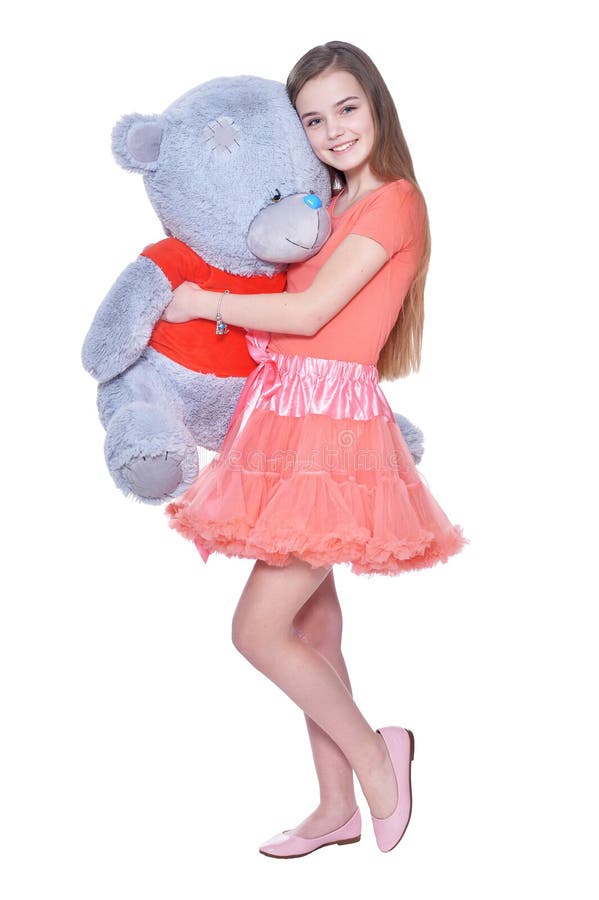 Happy little girl with toy bear posing